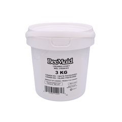 White container of BeeMaid creamed honey on a white background