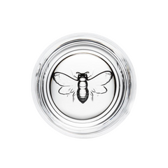 Clear glass lid with a bee design on a white background