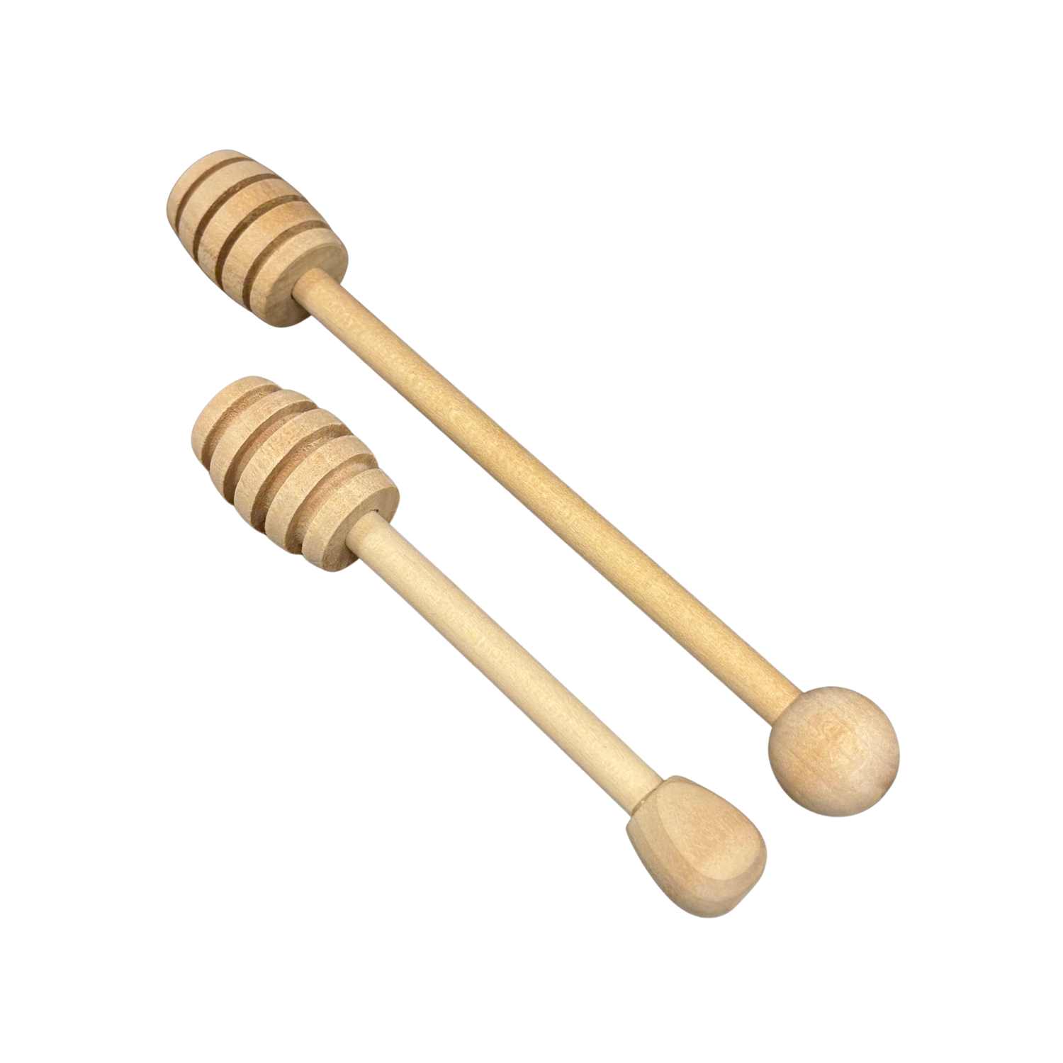Two wooden honey dipper sticks on a white background