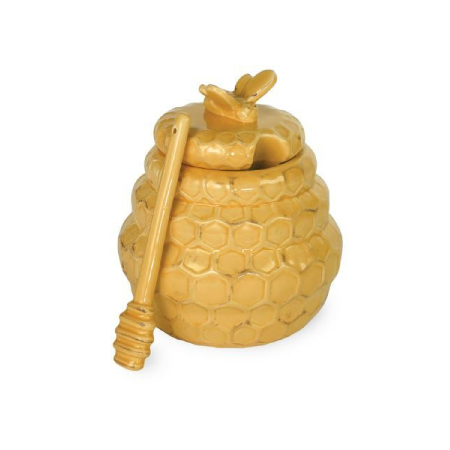 Yellow ceramic honey pot with raised honeycomb texture, a bee-shaped lid, and a matching honey dipper resting against the side on a white background.