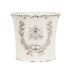 Large, decorative white planter with black floral and bee design on a white background