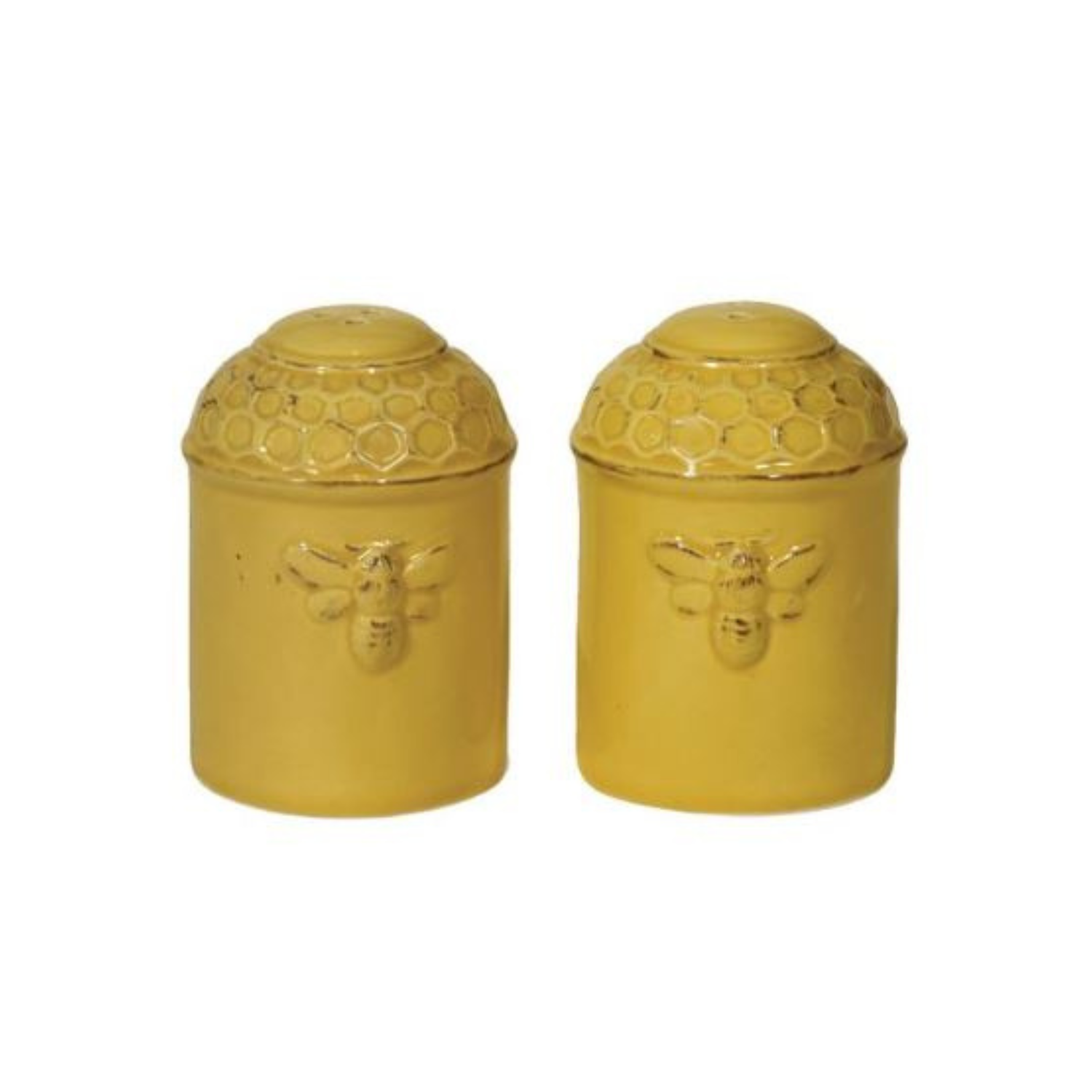 Set of two yellow ceramic shakers with raised honeycomb lids and embossed bee designs on the front, shown on a white background.