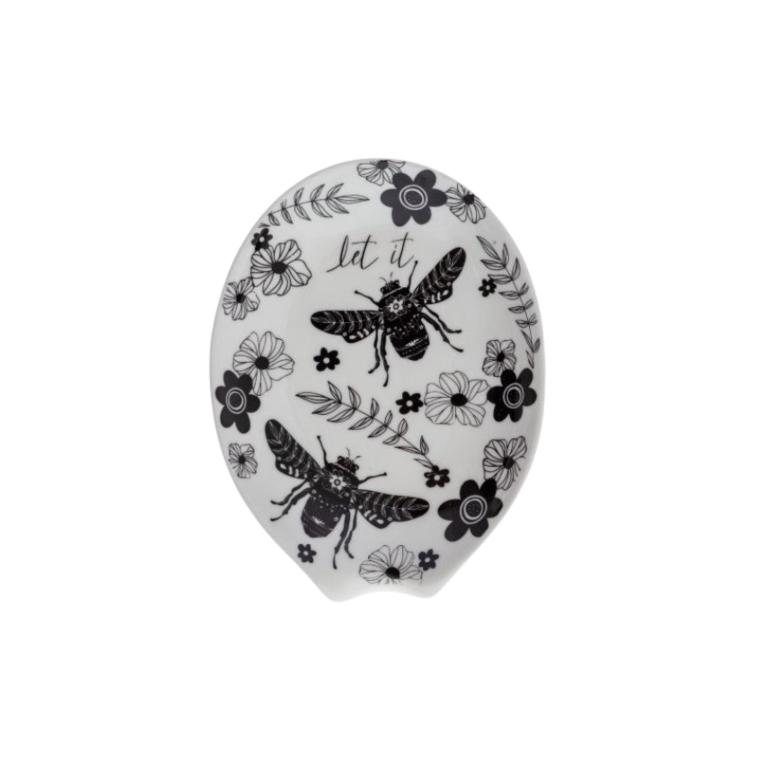 An oval-shaped white ceramic spoon rest decorated with black illustrations of bees, flowers, and leafy branches. The words “let it” are written in cursive near the top of the design.