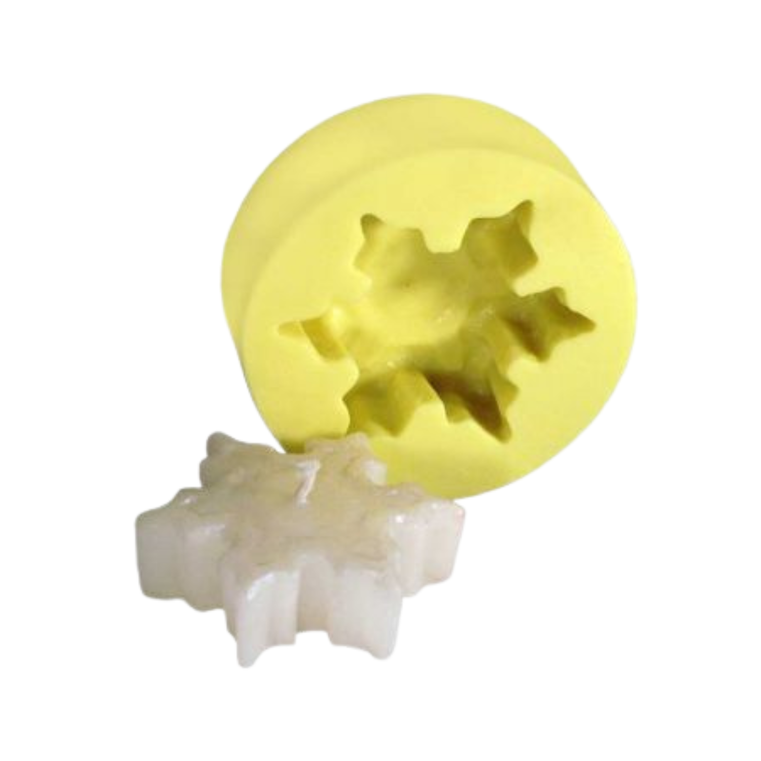 Yellow silicone mold next to its produced snowflake-shaped candle on a white background