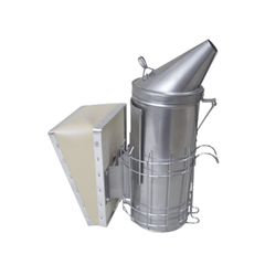 A stainless steel beekeeping smoker with a conical spout and a protective wire heat shield around the cylinder. A wooden and canvas bellows is attached to the side for pumping air to produce smoke.
