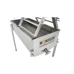 Metallic machine with 'Königin' branding on a white background