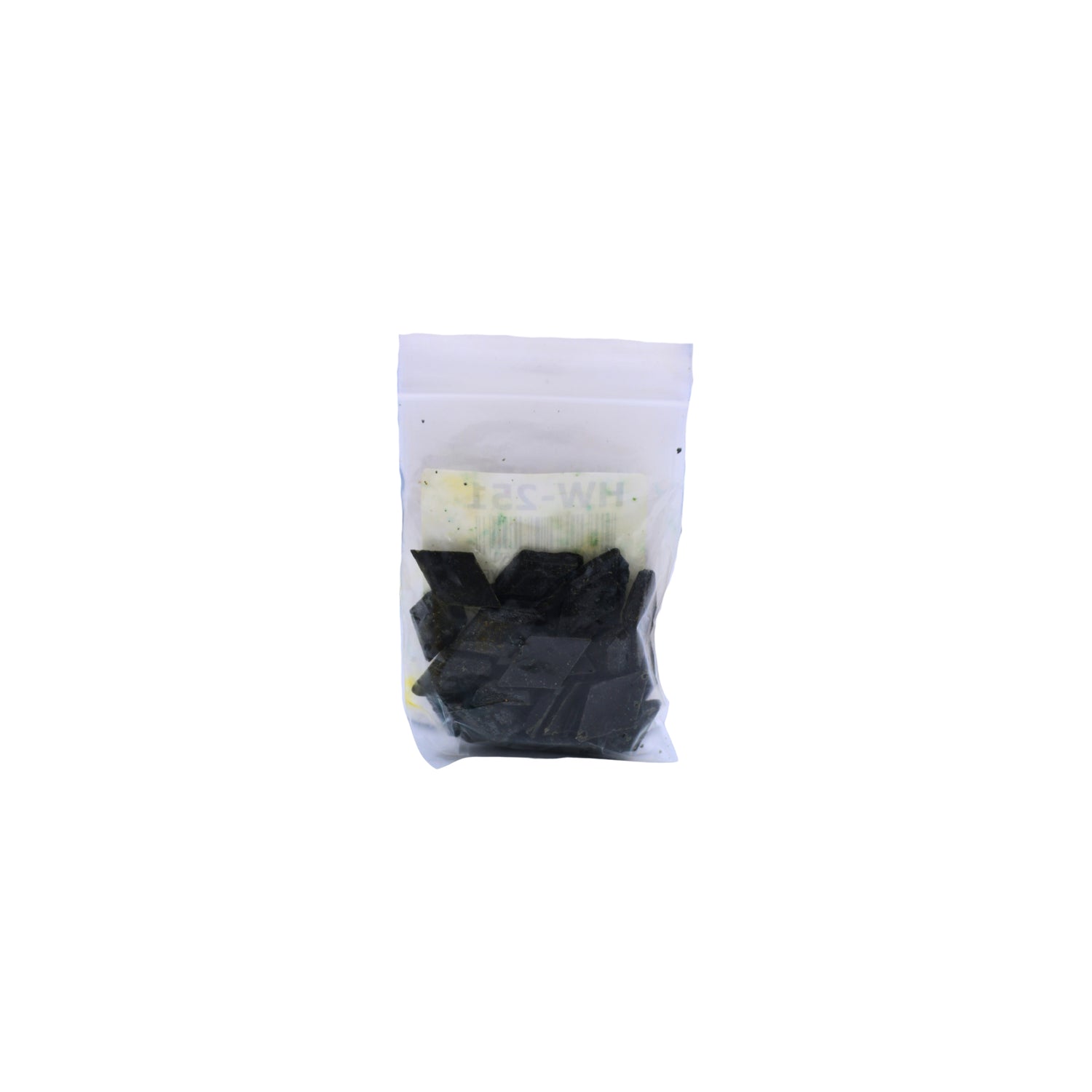 A small clear plastic pouch containing Christmas Green dye chips shown on a plain white background.