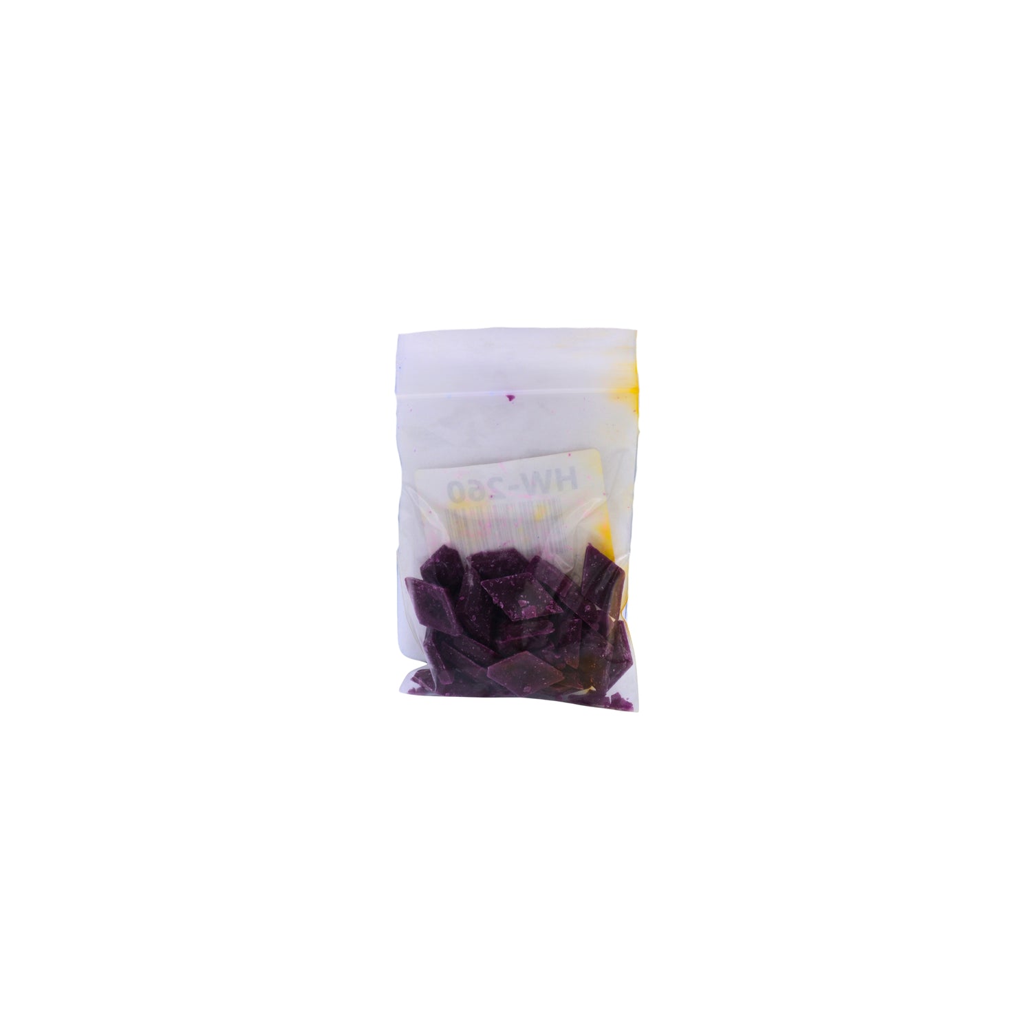 A small clear plastic pouch containing fuchsia dye chips shown on a plain white background.