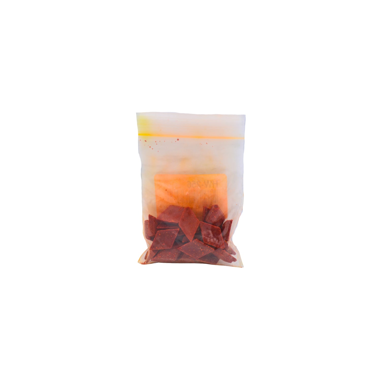 A small clear plastic pouch containing orange dye chips shown on a plain white background.