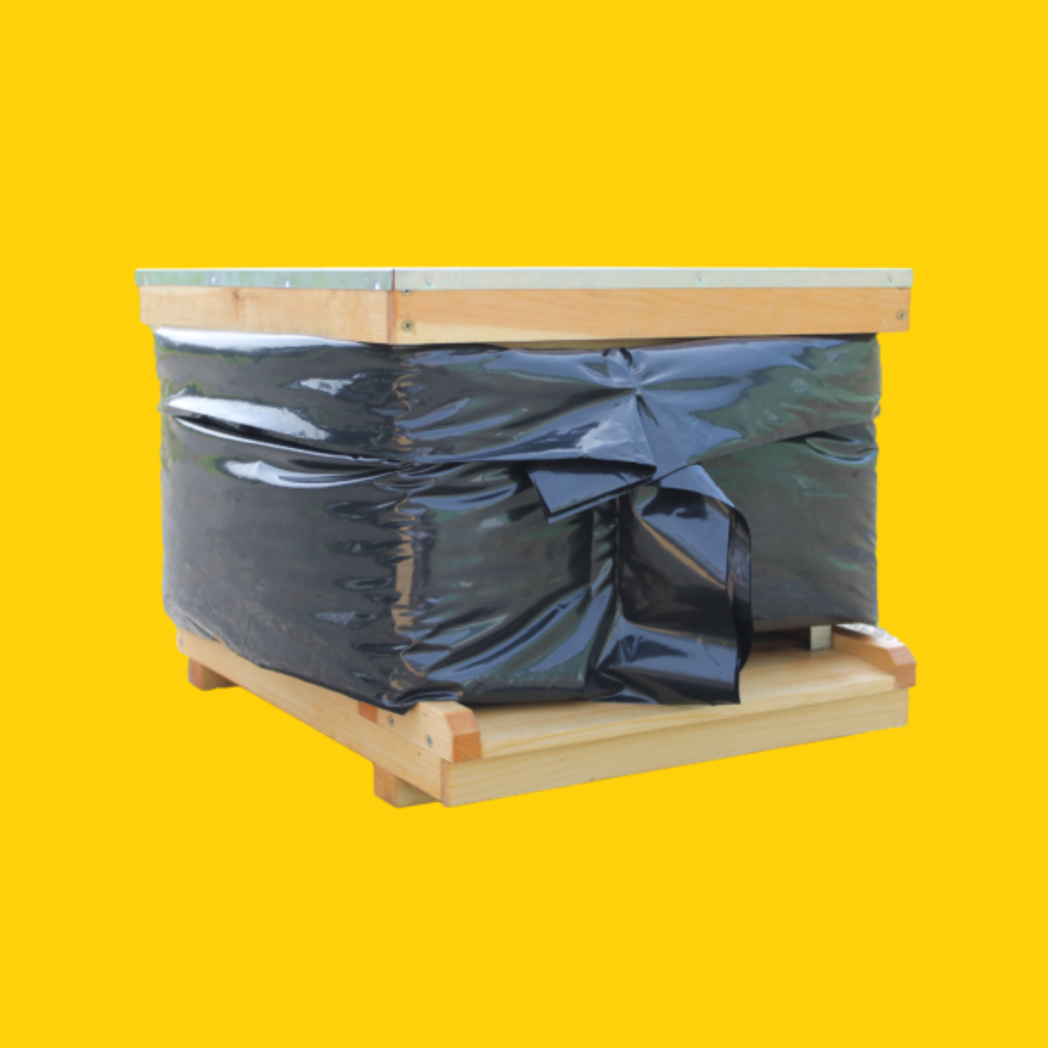 A black plastic winter wrap on a single hive box on a yellow background