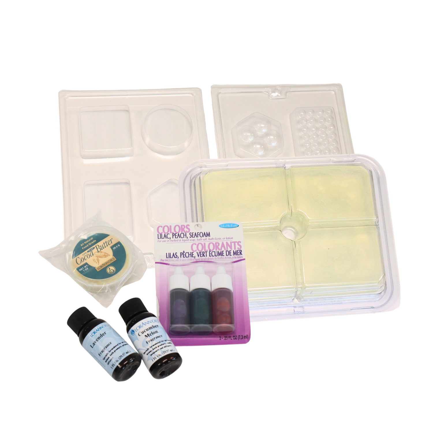 A collection of soap making supplies including a clear glycerine soap base, liquid soap colors in Lilac, Peach, and Seafoam, massage bars soap mold, geometric shapes soap mold, cocoa butter, cucumber melon fragrance, and lavender fragrance on a white background