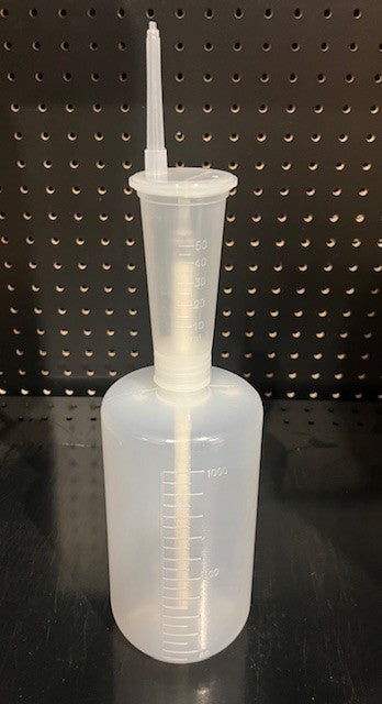 Opaque Bottle on black background with a tip and ML measurements