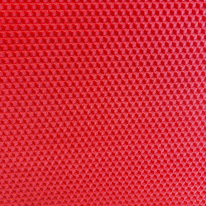 A close up of a red beeswax craft sheet 