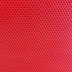 A close up of a red beeswax craft sheet 